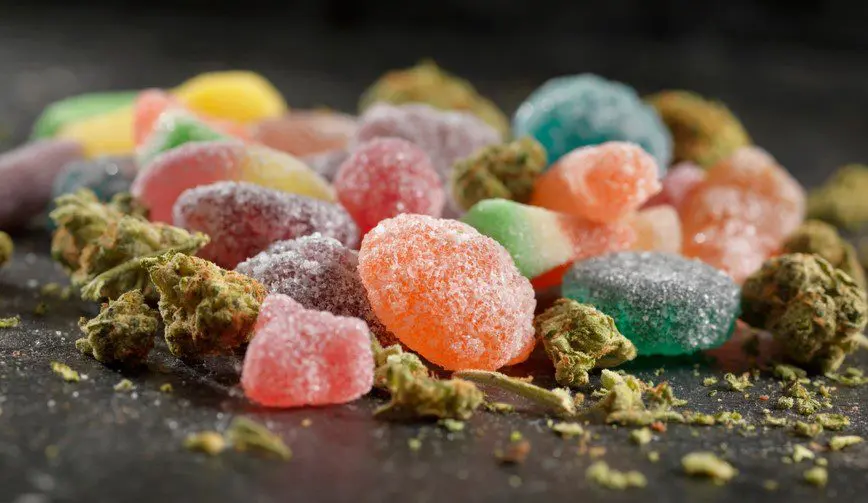 CBD gummies and THCa flower in a pile