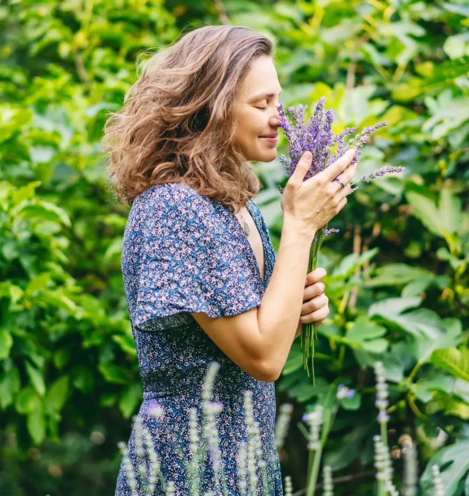 woman inhaling lavender flowers