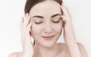 Woman rubbing head in need of Delta 9 or CBD