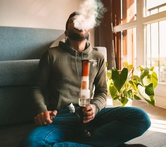 man exhaling THCa diamonds smoke